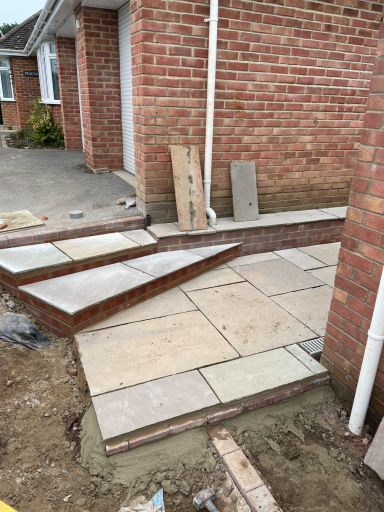 large Indian sandstone patio installed in a dorset garden with natural stone paving
